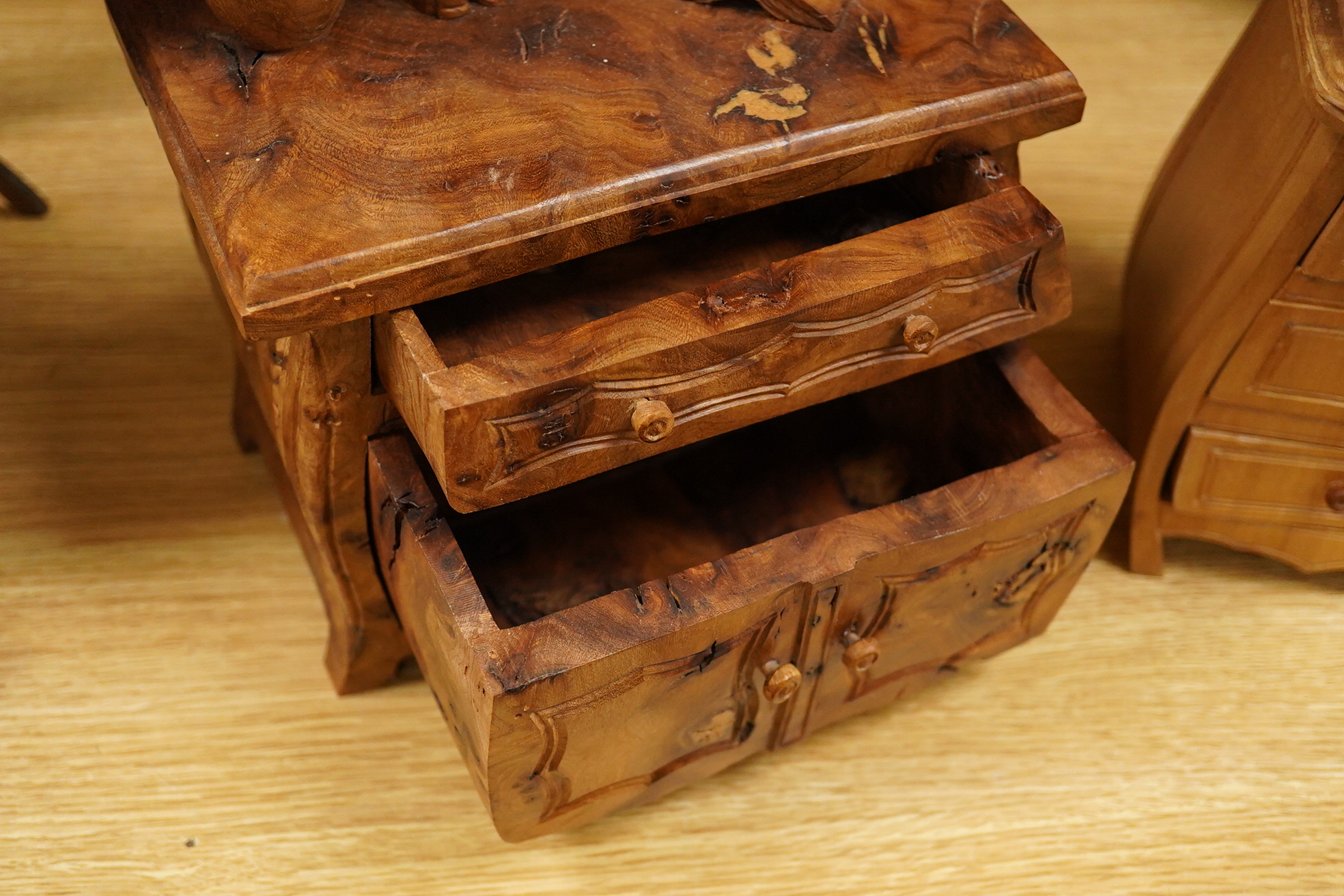 Two Piere Decorse (b.1953), a naturalistically modelled sculpture of a miniature carved novelty bureau and a sideboard, both surmounted with books and a lamp, largest 39cm high